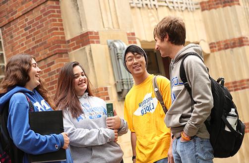 multi cultural students in front of office